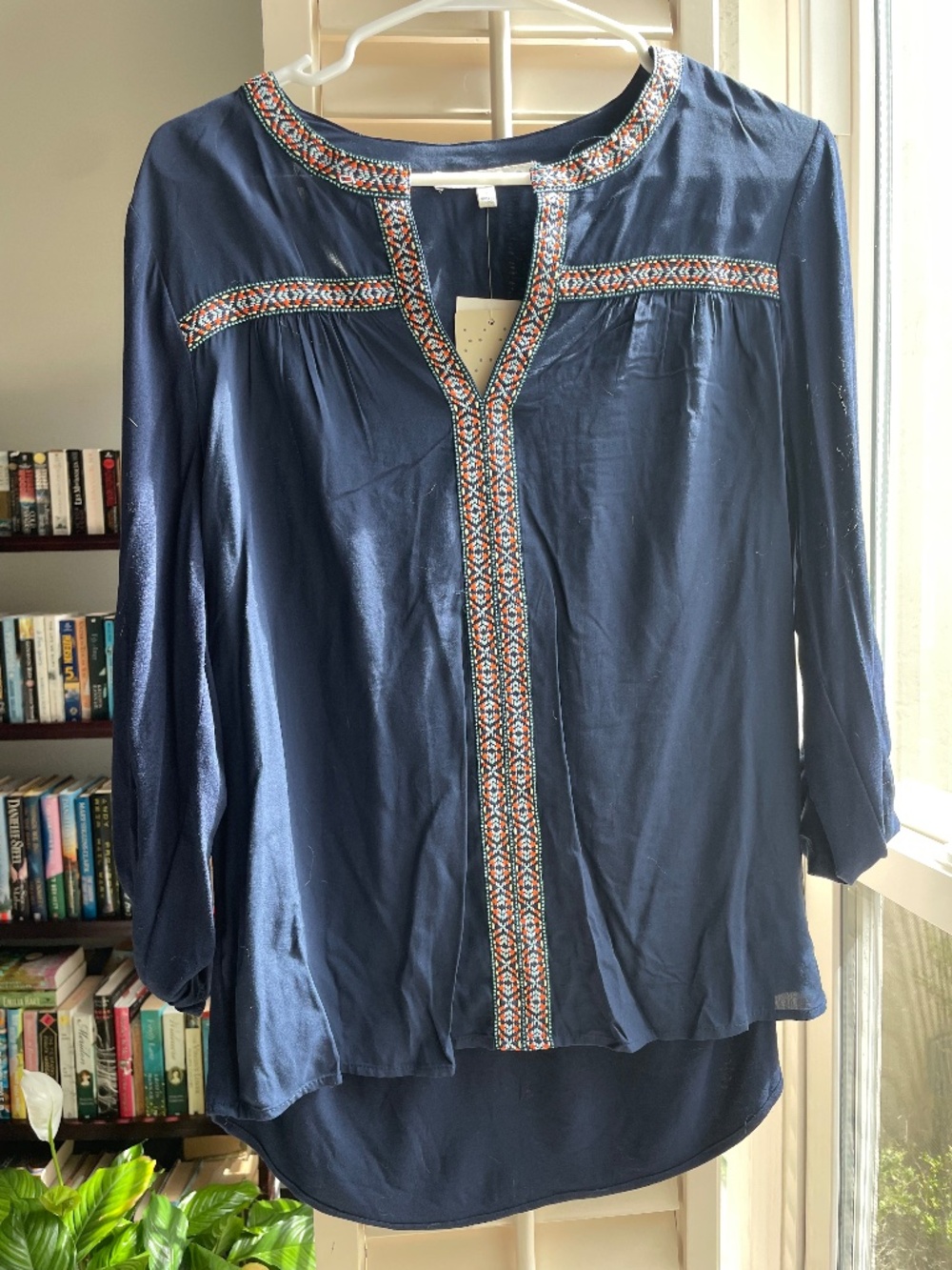 Navy long sleeved blouse with embroidered trim